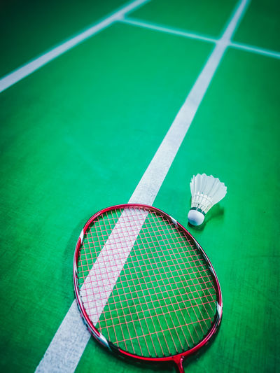 High angle view of badminton and shuttlecock on court