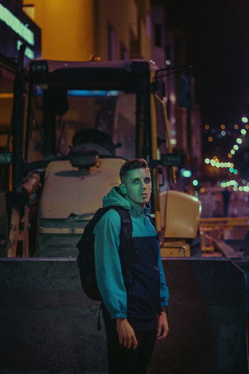 Portrait of young man standing at night