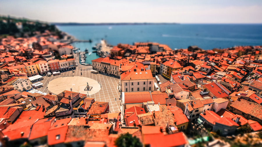 Tilt-shift image of cityscape against sky
