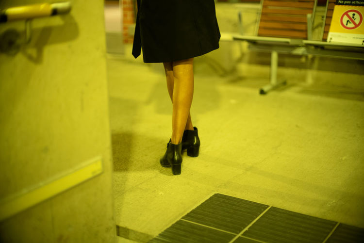 Low section of woman walking on floor