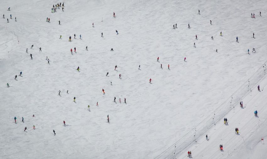 High angle view of people on snow covered landscape