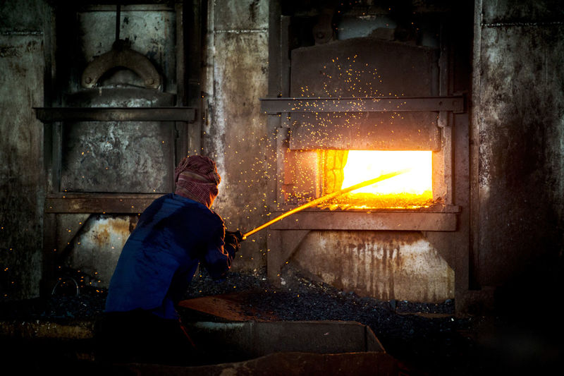 Man melting iron at factory