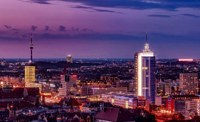 Illuminated buildings in city at dusk