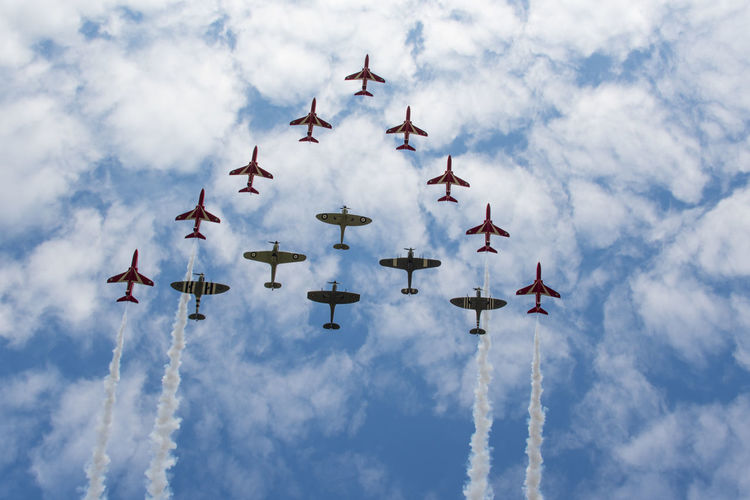 Low angle view of airshow against sky