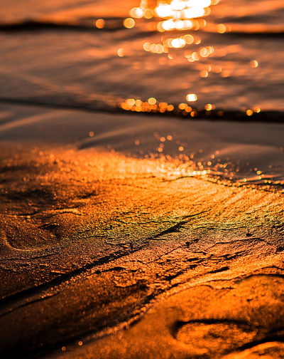 Close-up of beach during sunset