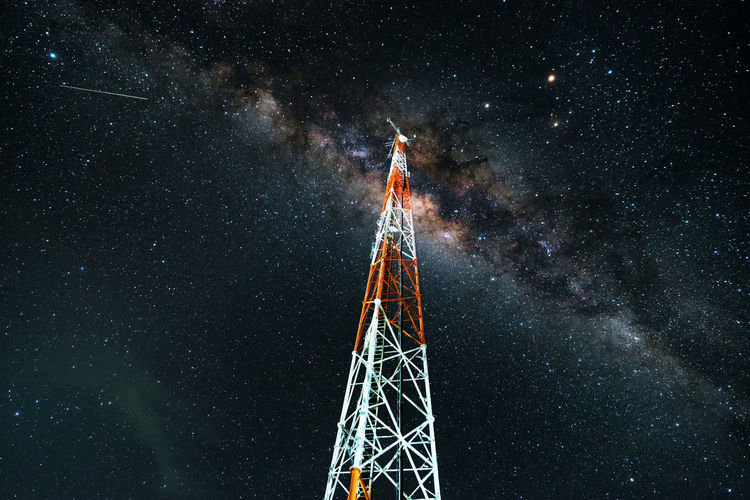 Low angle view of milky way across the telecom tower
