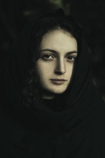 Close-up portrait of young woman at night