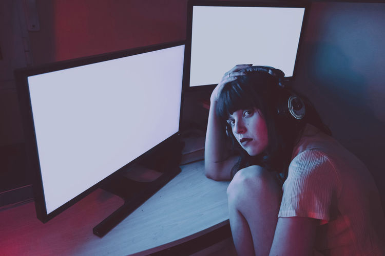 Portrait of young woman using mobile phone at home
