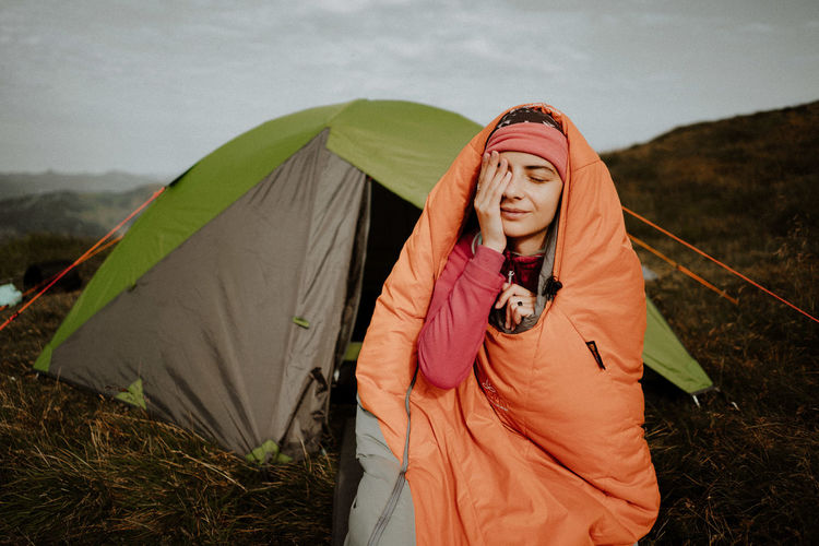 Portrait of woman sitting on tent