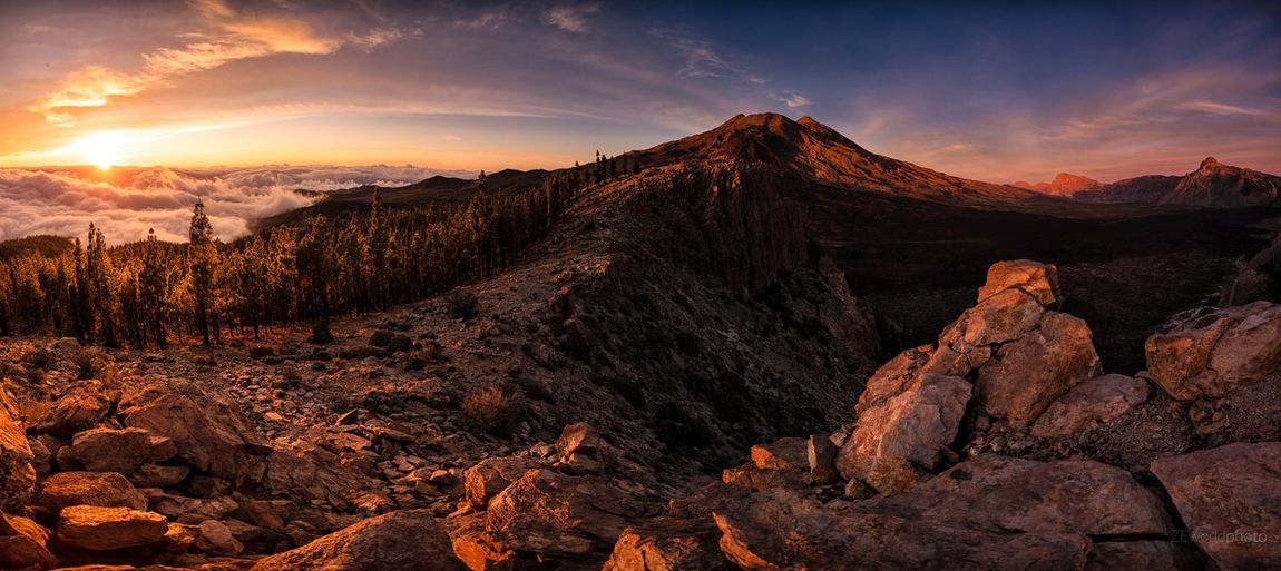 Scenic view of rocky mountains against sky during sunset