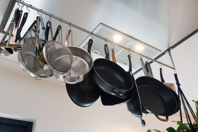 Low angle view of cooking utensil hanging at kitchen