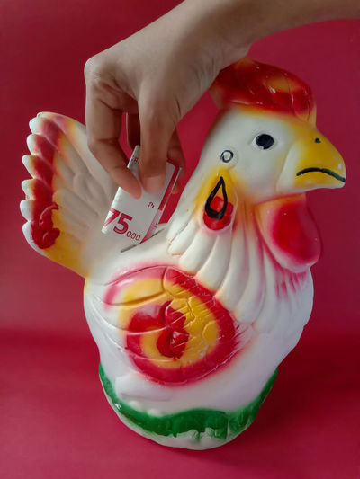 Save money by using a piggy bank in the shape of a rooster