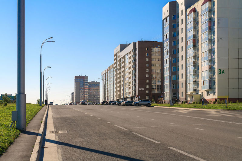 Street amidst buildings against clear sky