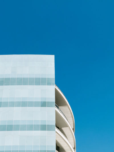 Low angle view of building against clear blue sky