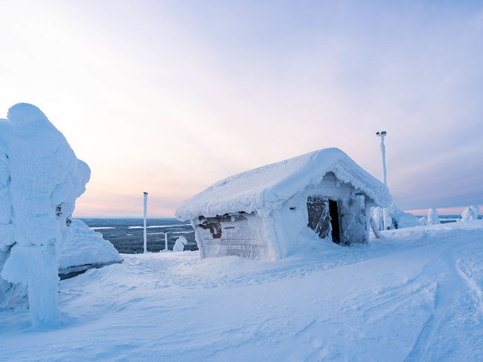 View of a snow covered wooden building in ruka ski resort, kuusamo, finland