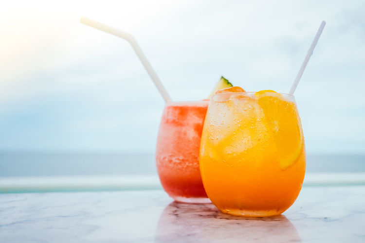 Close-up of cocktails on beach
