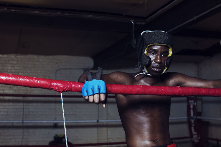 Boxer looking away while standing in boxing ring