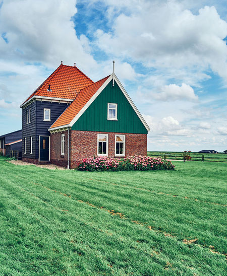 Colorful house in field on marken island in netherlands 