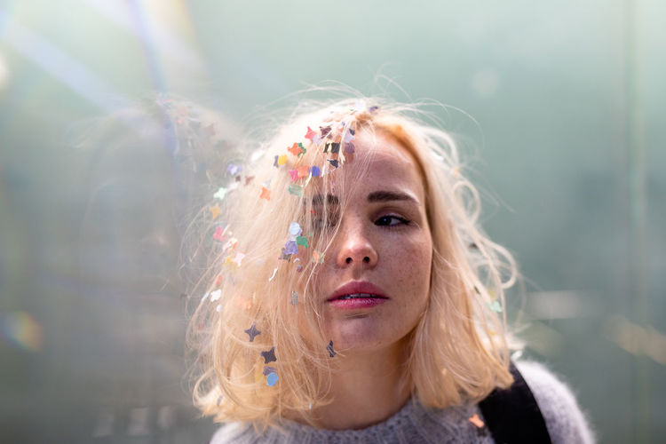 Close-up of woman with confetti in hair