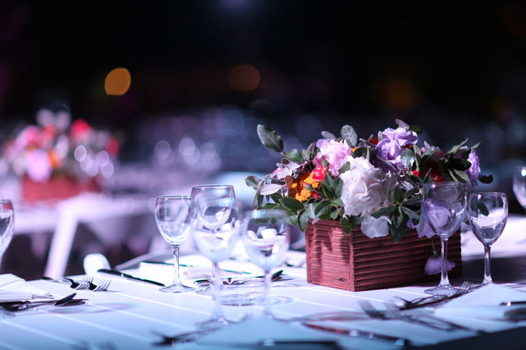 Place setting and bouquet on table at wedding reception