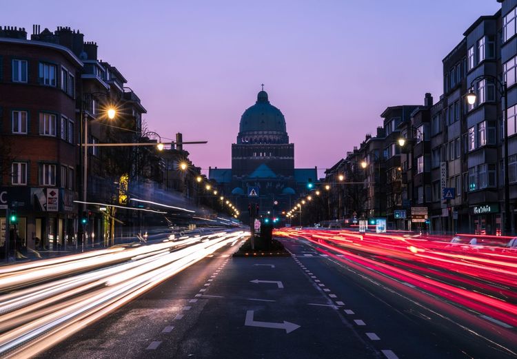Light trails on street in front of basilica of the sacred heart at dusk