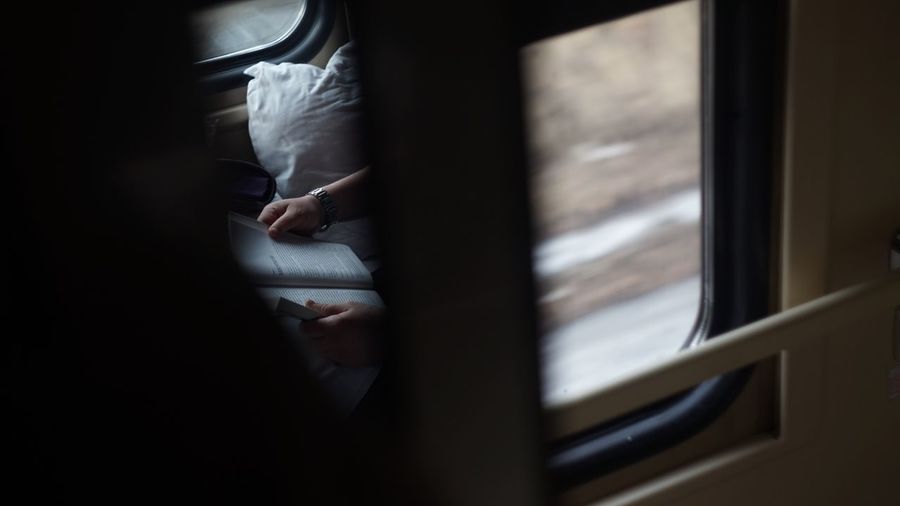 Close-up of woman reading on train