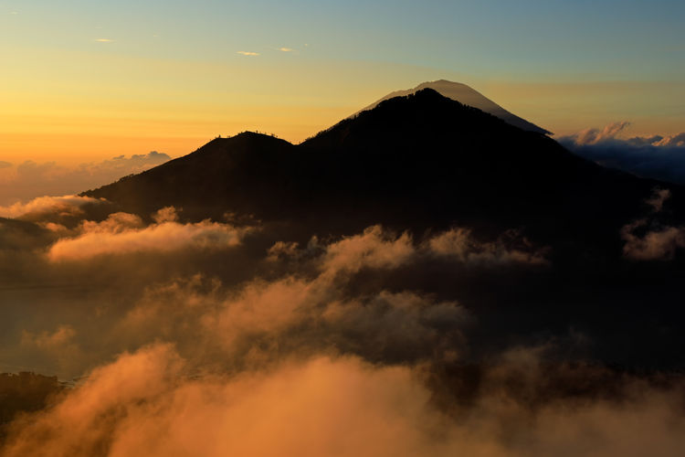 Scenic view of clouds and mist at sunrise from the top of mount batur, bali, indonesia
