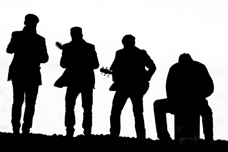 Silhouette people against clear sky