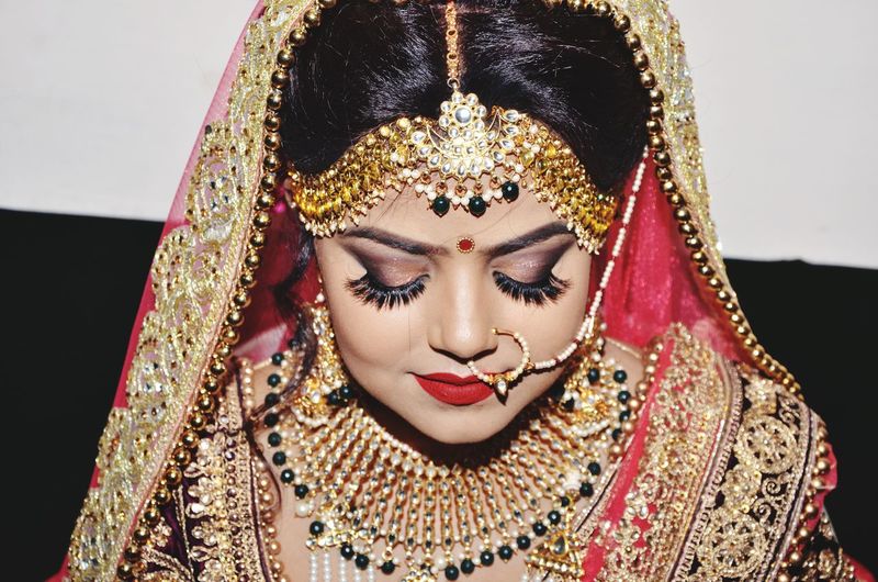 Close-up of bride wearing sari with jewelry during wedding ceremony