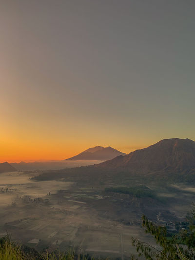 Scenic view of landscape against sky during sunrise