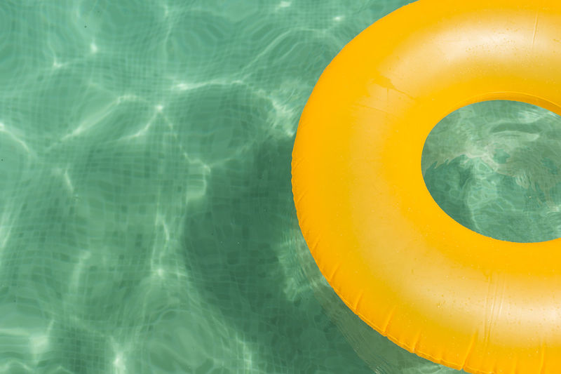 High angle view of yellow inflatable raft in swimming pool