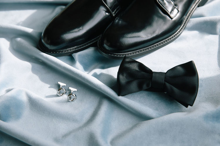 Groom accessories. shoes, bow tie, and cufflinks.