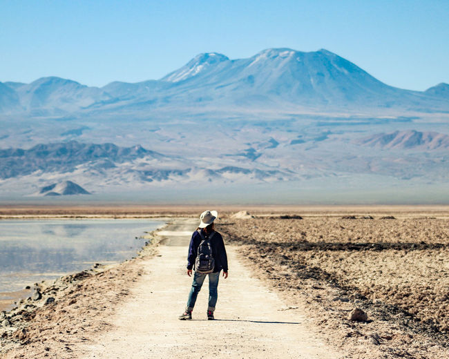 Full length rear view of woman on arid landscape