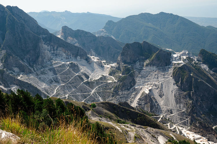View of the carrara marble quarries and the transport trails carved into the side of the mountain.