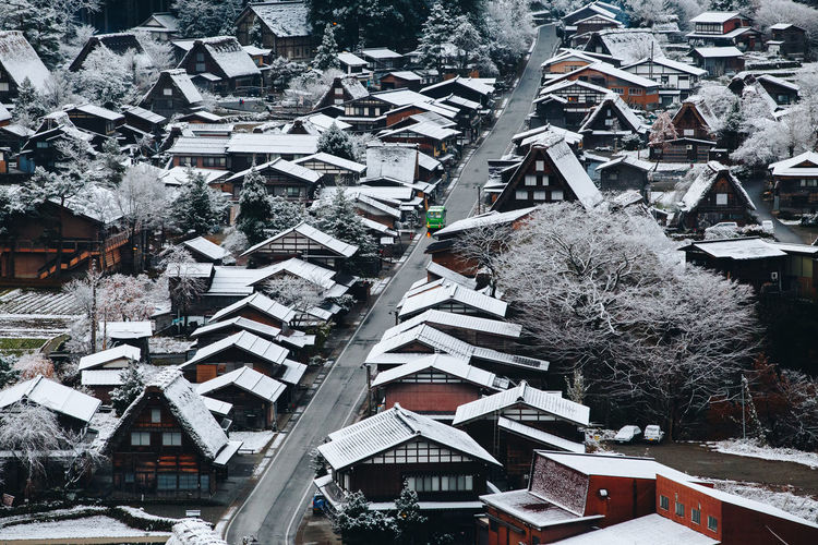 High angle view of snow covered houses in city