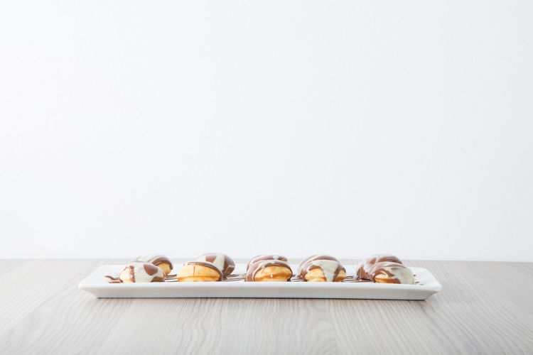 Close-up of cupcakes on table against white background