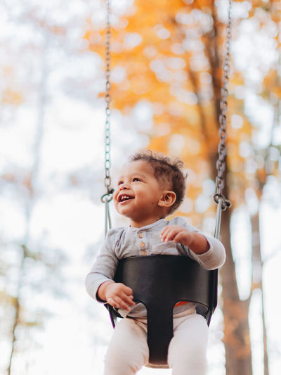 Happy boy on swing at playground