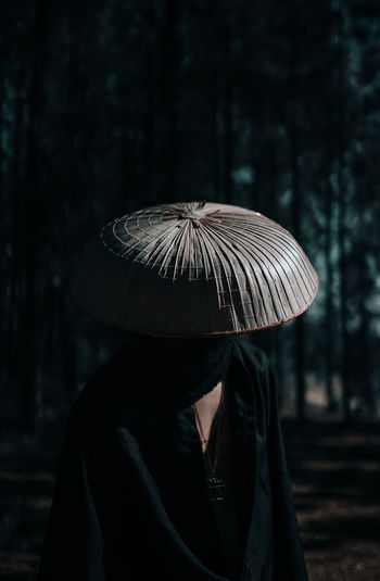 Rear view of woman wearing hat in forest