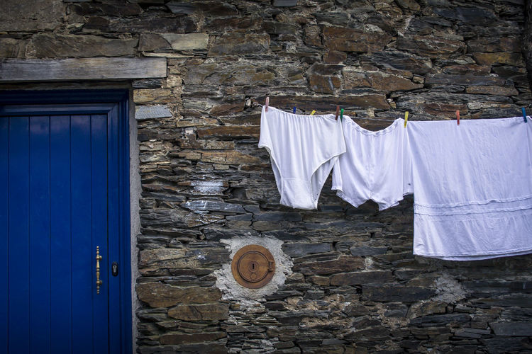 Clothes drying against white wall
