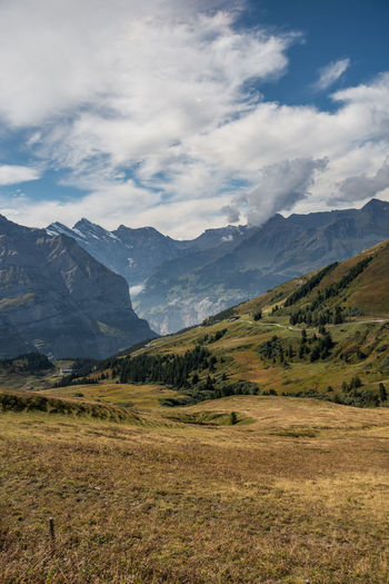 Scenic view of mountains against cloudy sky