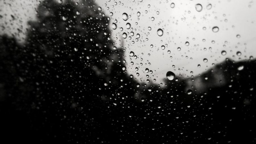 Full frame shot of wet window during rainy season
