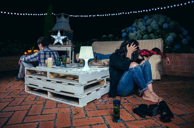 Drunk friends during party in backyard at night