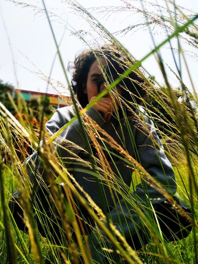 Portrait of woman on grass in field
