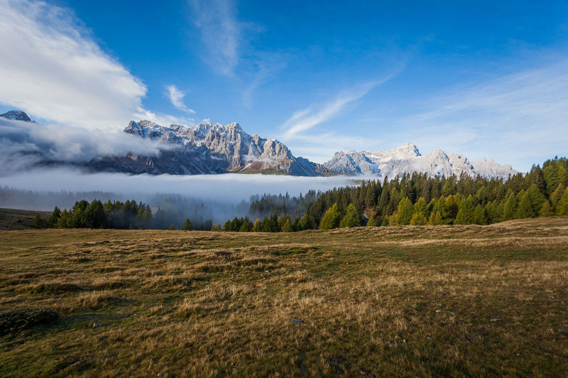 Sunrise with clouds dancing around wonderful dolomite peaks, south tyrol, italy