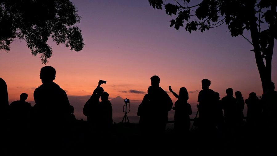 Silhouette of people at sunset