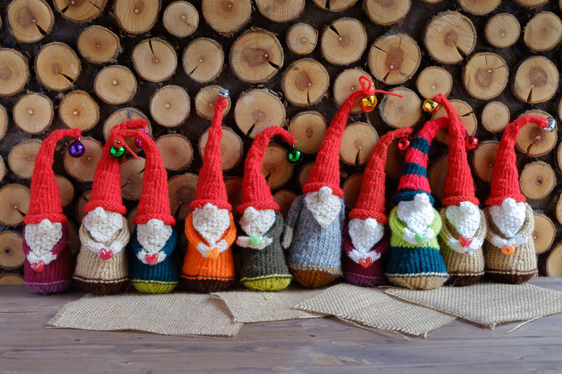 Woolen garden gnomes by wooden decoration