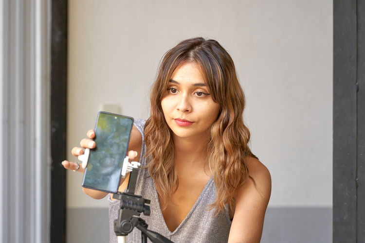 Young woman using mobile phone at home