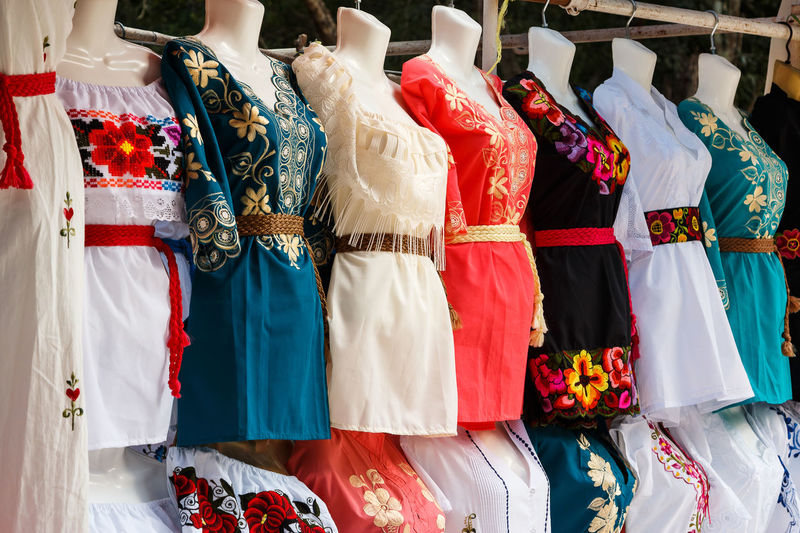 Various clothes hanging in store for sale in market