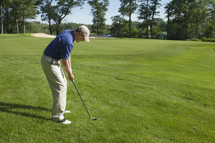 Side view of man playing golf