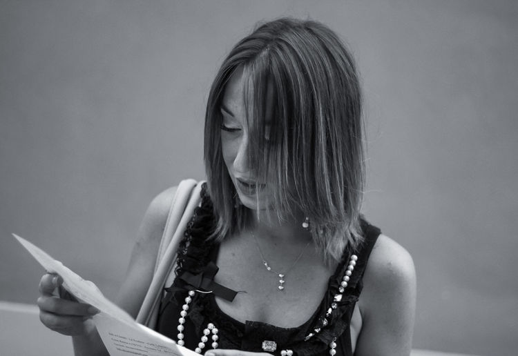 Close-up of woman reading paper 